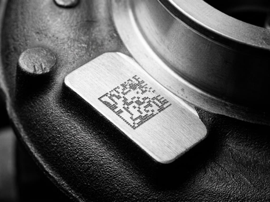 DataMatrix code, marked with a dot peen marking machine on a cast steel part.